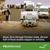 A car with a trailer tries to cross a flooded roadway. Onlookers watch from behind. #BeInformed