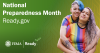 Two women wearing rainbow shirts hug. National Preparedness Month.