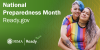 Two women wearing rainbow shirts hug. National Preparedness Month.